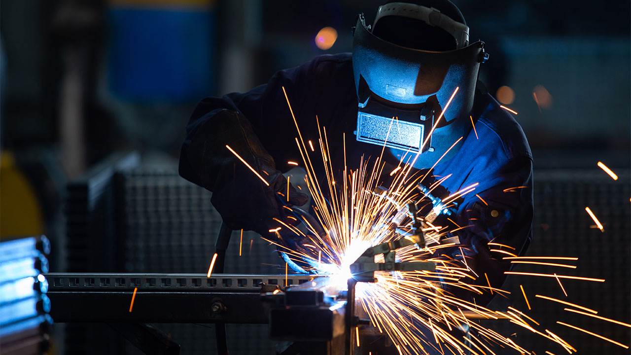Photo of a person in protective gear welding