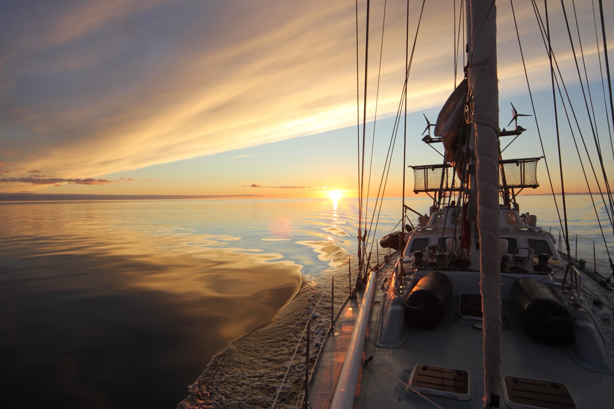 Sailboat at sunset on calm water