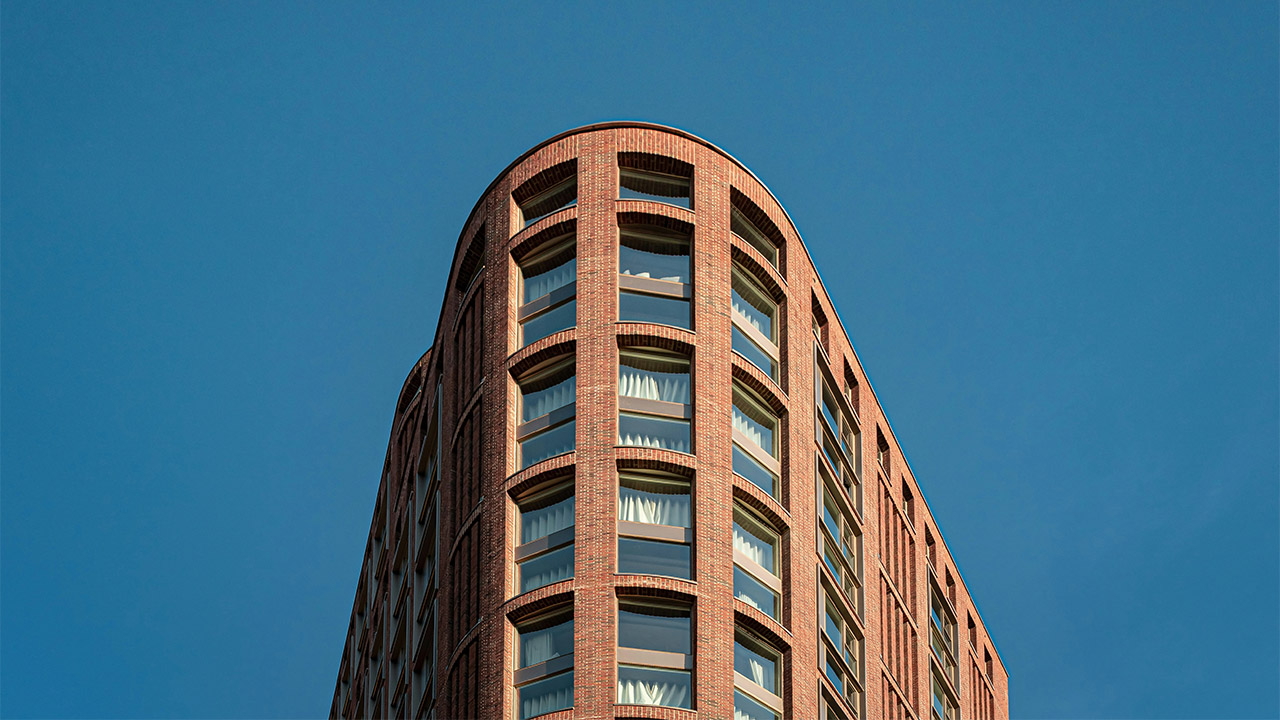 Brown high rise building with blue sky background