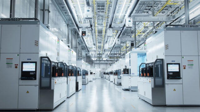 Two rows of industrial machines in a semiconductor manufacturing plant