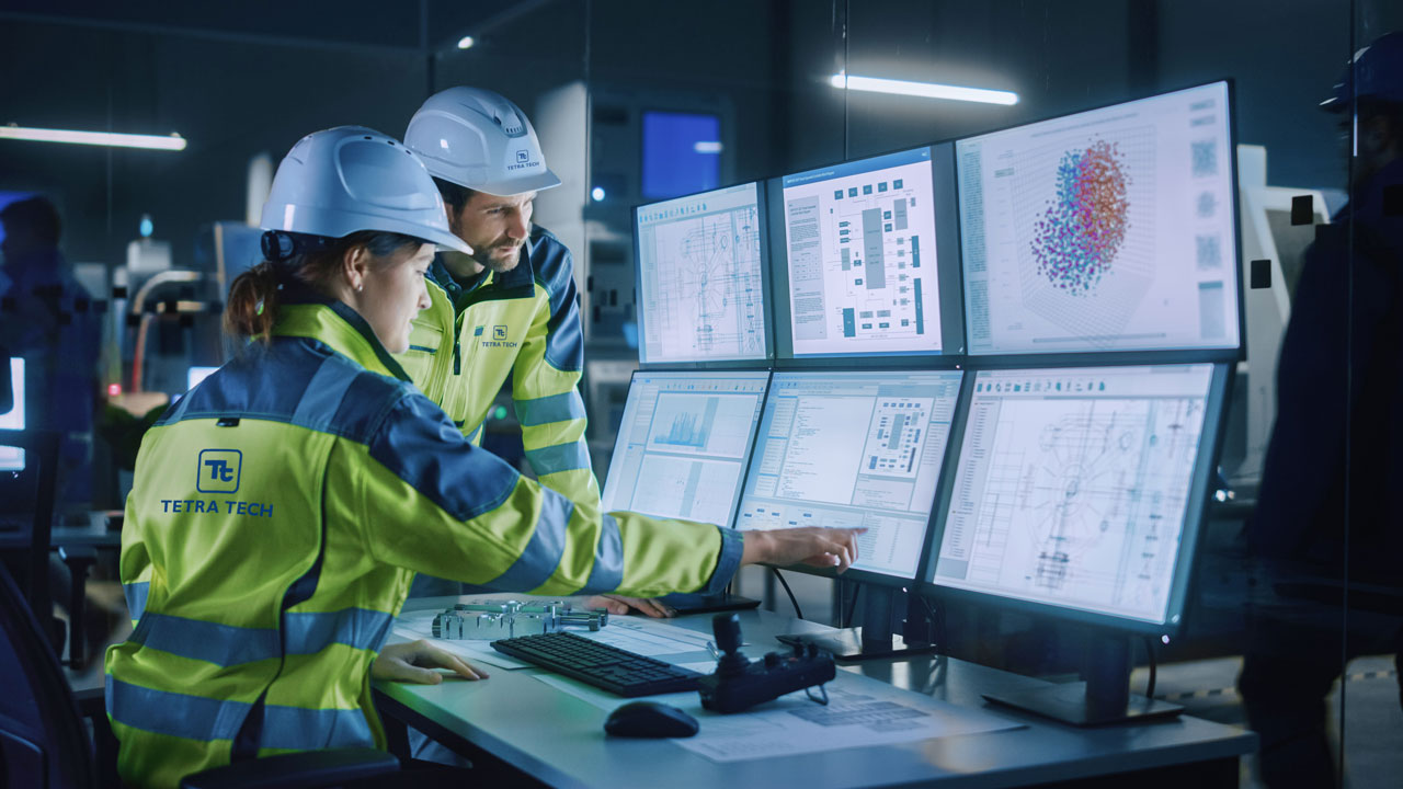 One employee training another how to operate a system