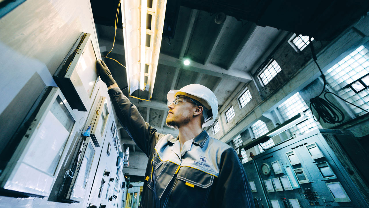 An operator checking breakers in a power facility
