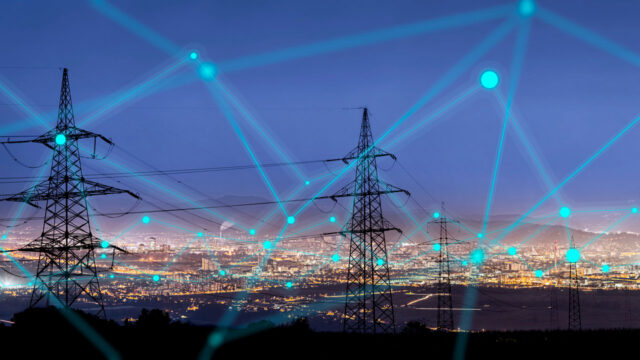 A stock photo of transmission lines against a night sky with a line and dot connection graphic overlaid on the top of the image