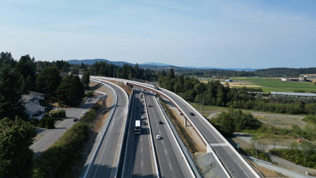 Aerial view of the completed Keating Cross Road Flyover carrying traffic over Highway 17 near Victoria, British Columbia