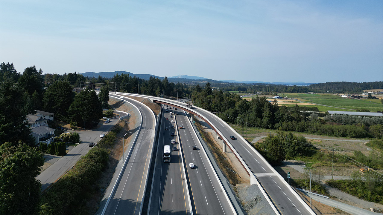 Aerial view of the completed Keating Cross Road Flyover carrying traffic over Highway 17 near Victoria, British Columbia