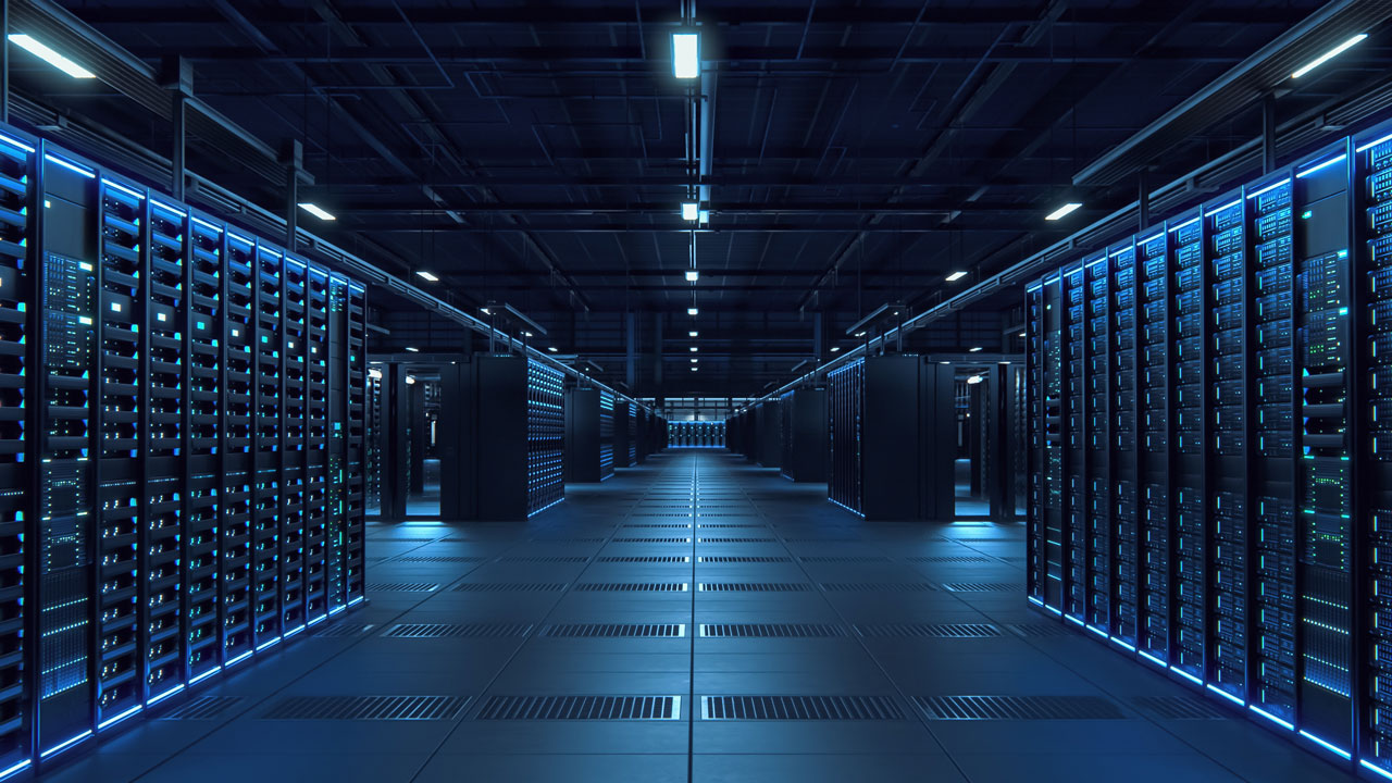 Rows of illuminated server racks line a modern data center aisle